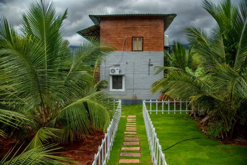 Two-storey farm block rising above the coconut grove