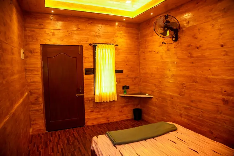 Wooden guest room with yellow curtains and warm cove lighting